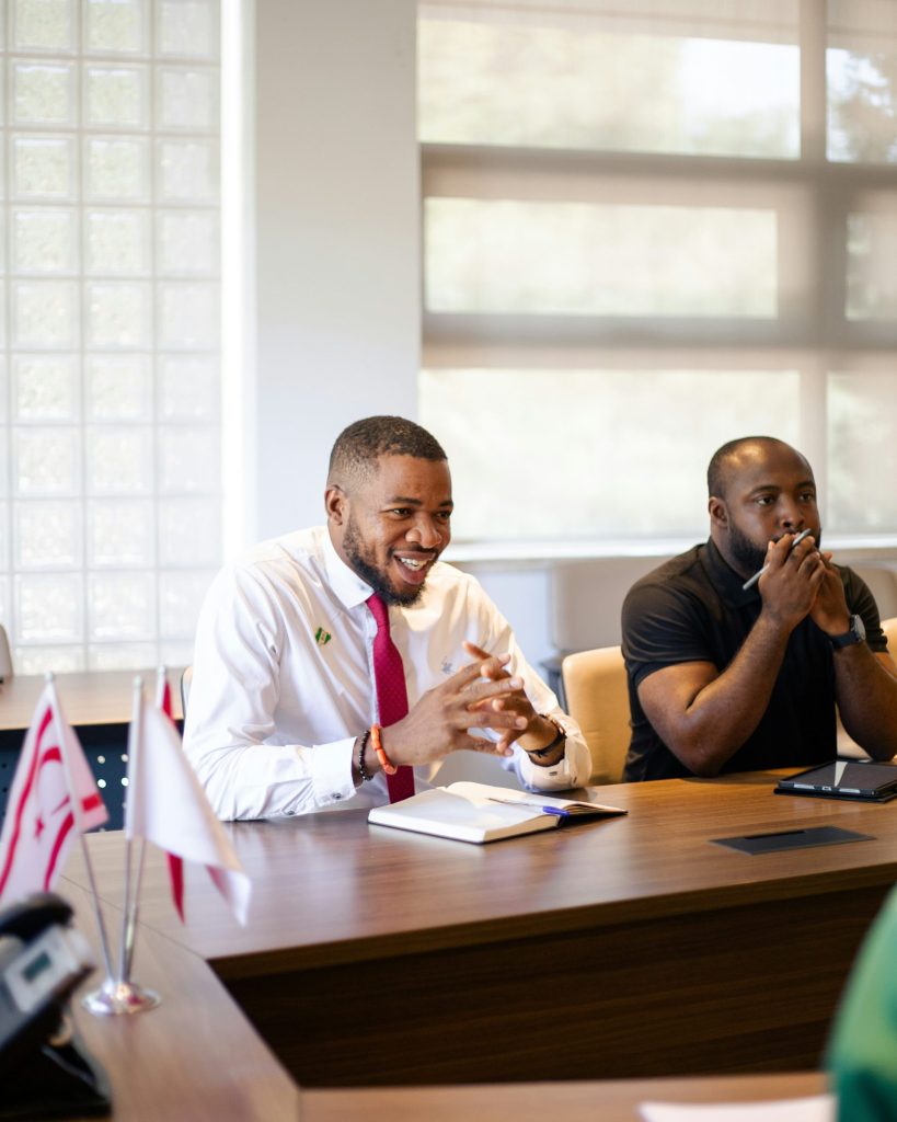 Two men in a meeting at a conference table.